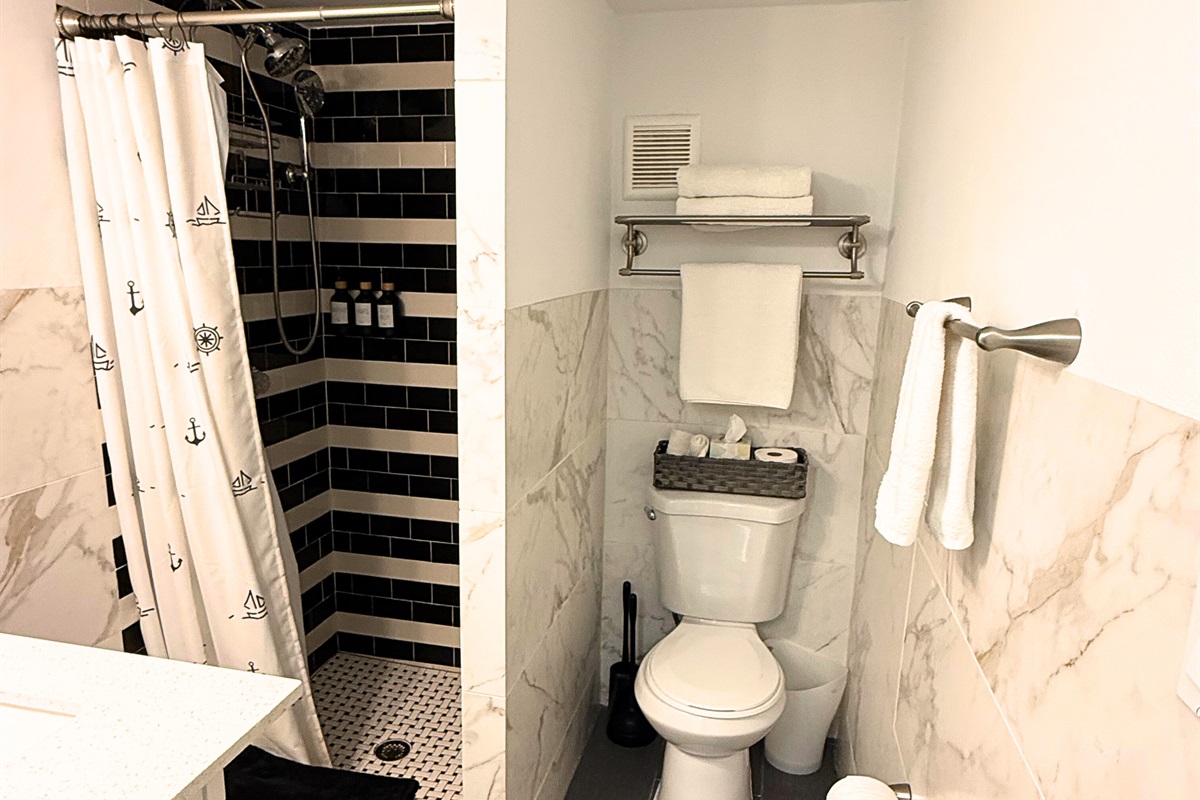 Guest bathroom is down the hall from the two guest rooms