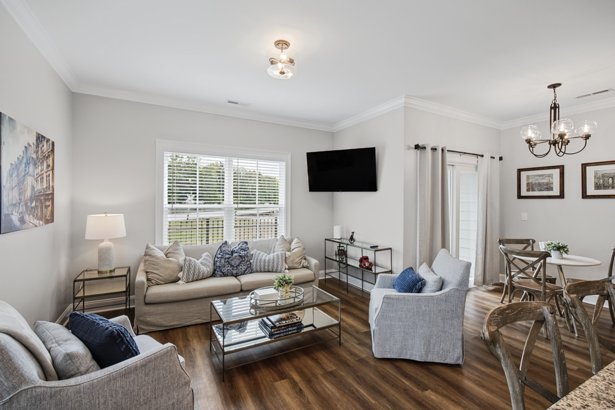 Comfortable living room with a large Smart TV and seating for the whole group