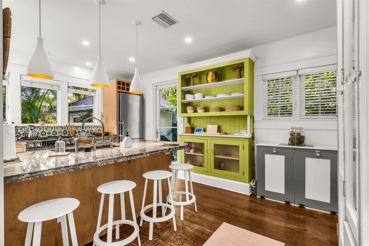 This fully equipped kitchen features a gas range stove, Nespresso, Keurig, and drip coffee makers, plus a blender and serviceware for 10. French doors lead directly to the patio with an outdoor dining table for 6—perfect for al fresco meals in paradise.