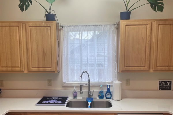 The open concept kitchen adorned with lots of natural light welcomes you from your travels. 