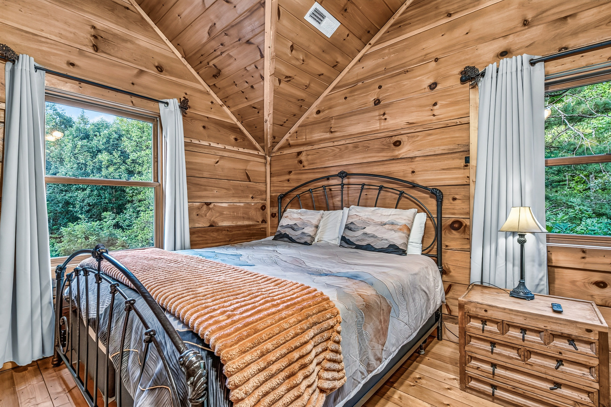 Wake up to sunshine and treetop views from windows on both sides of this airy bedroom space.