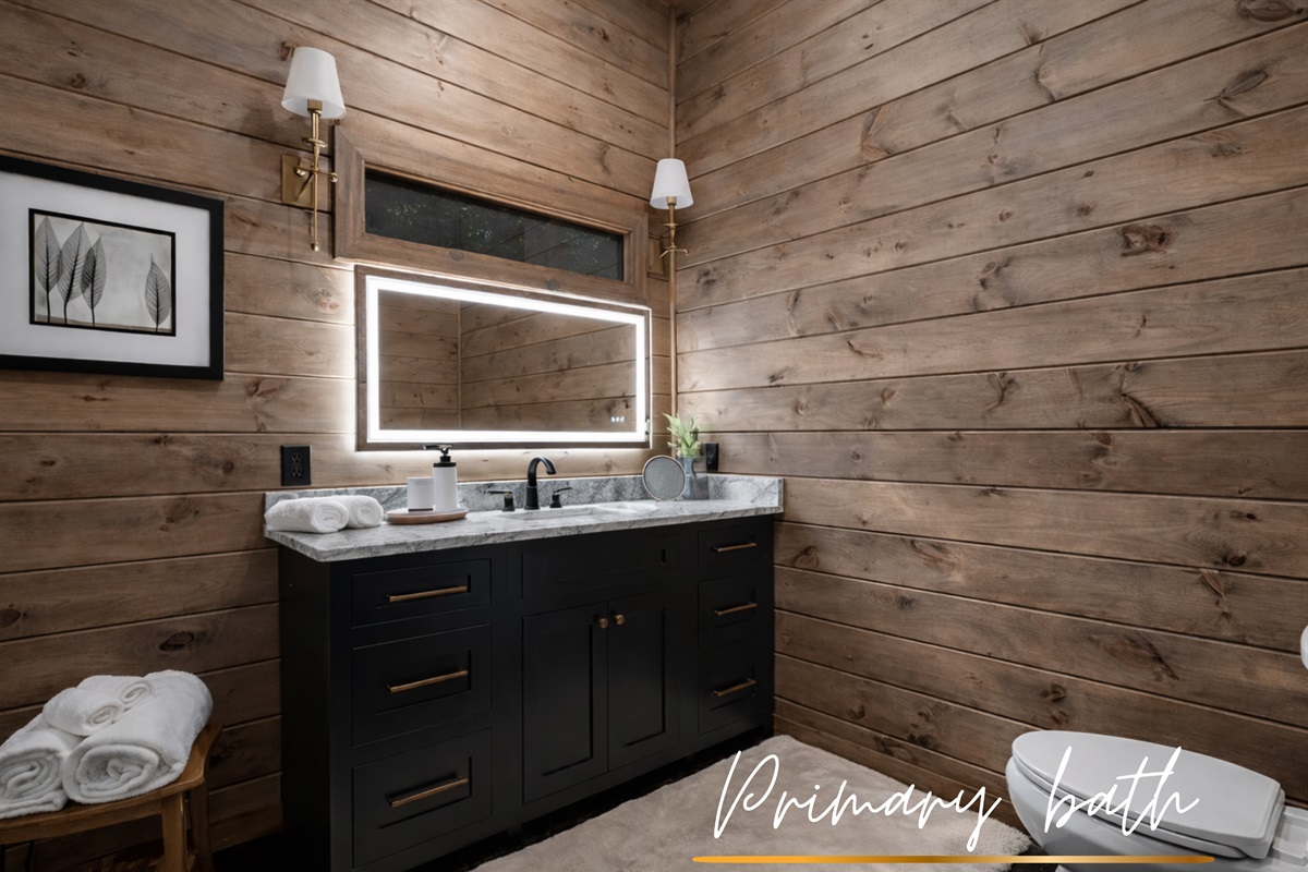 Lighted mirrors + clean lines, elegance at eye level.