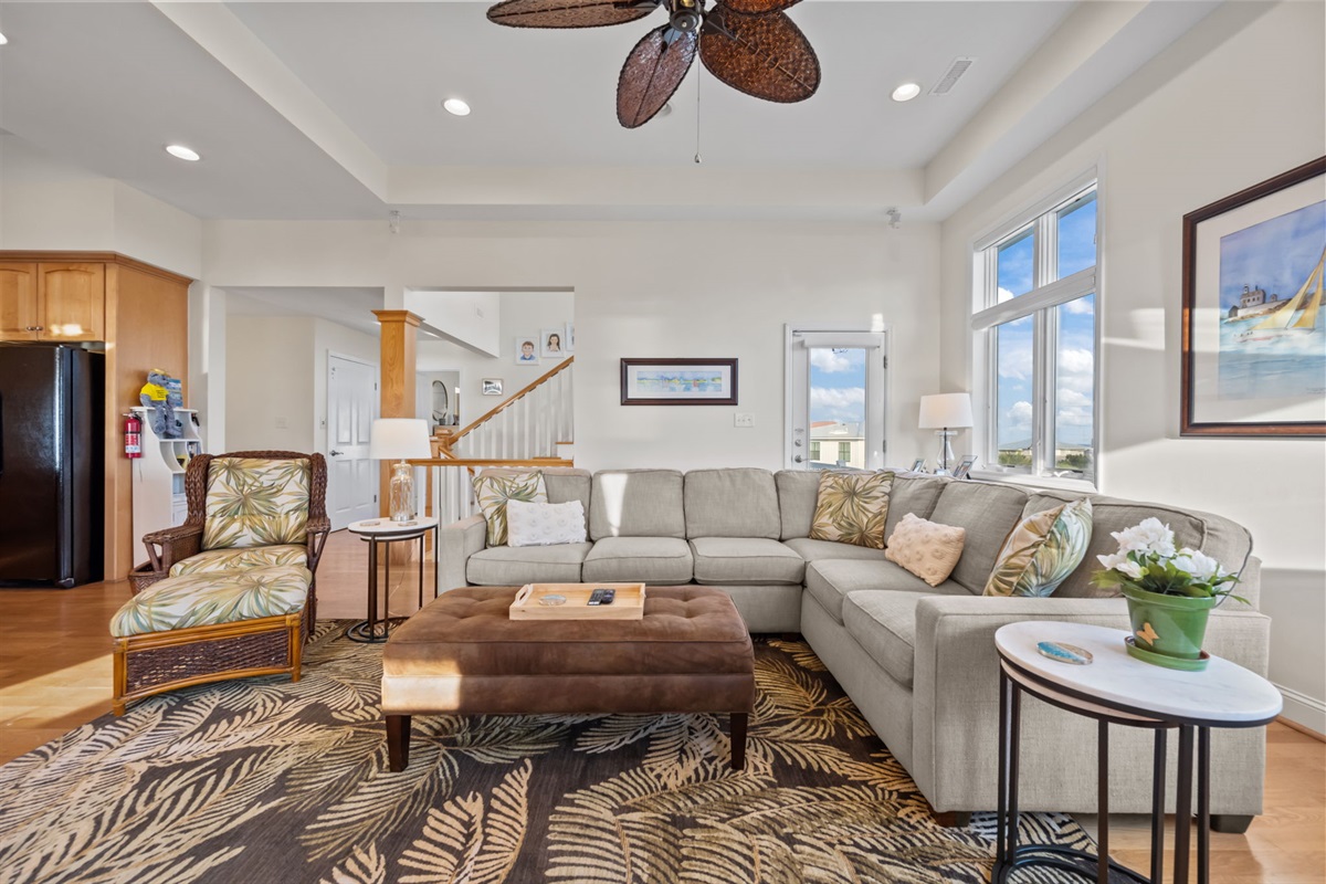 Open-concept living room with comfortable seating and natural light throughout