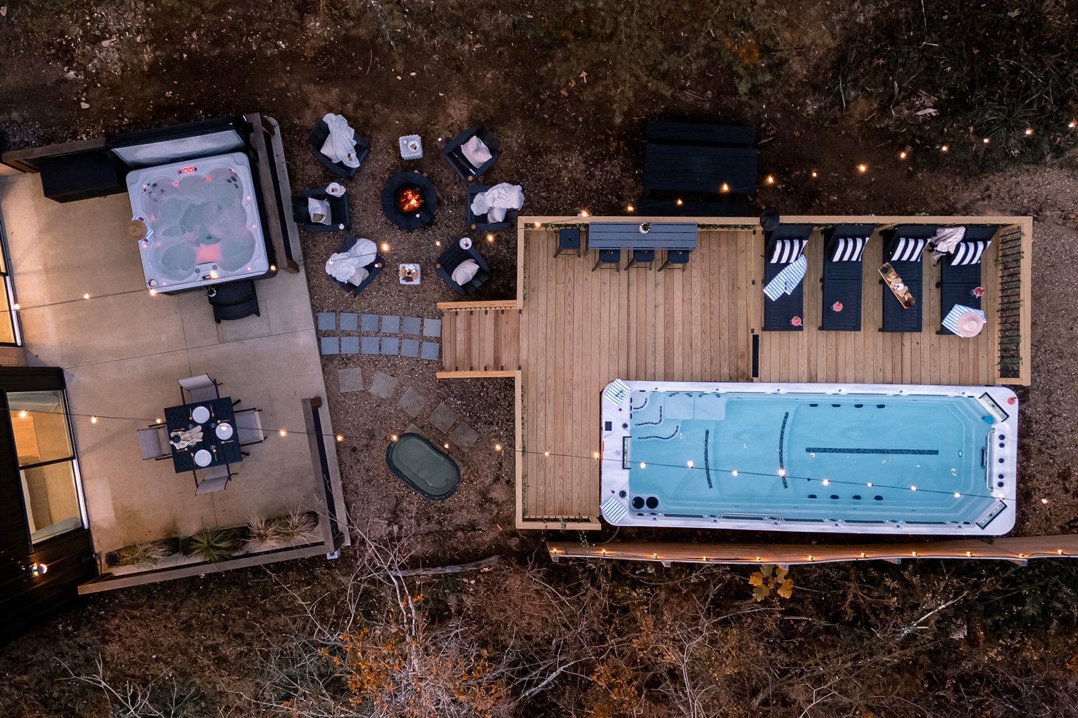 {Aerial View – Swin Spa Deck} Where the forest drops away and your private 21-ft heated swim spa, fire pit, and terraces rise to meet the mountains.