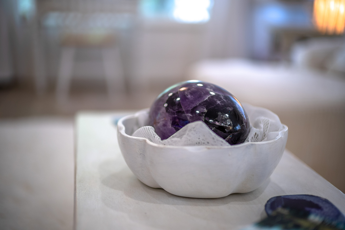 An elegant amethyst crystal sphere brings natural beauty and tranquility.