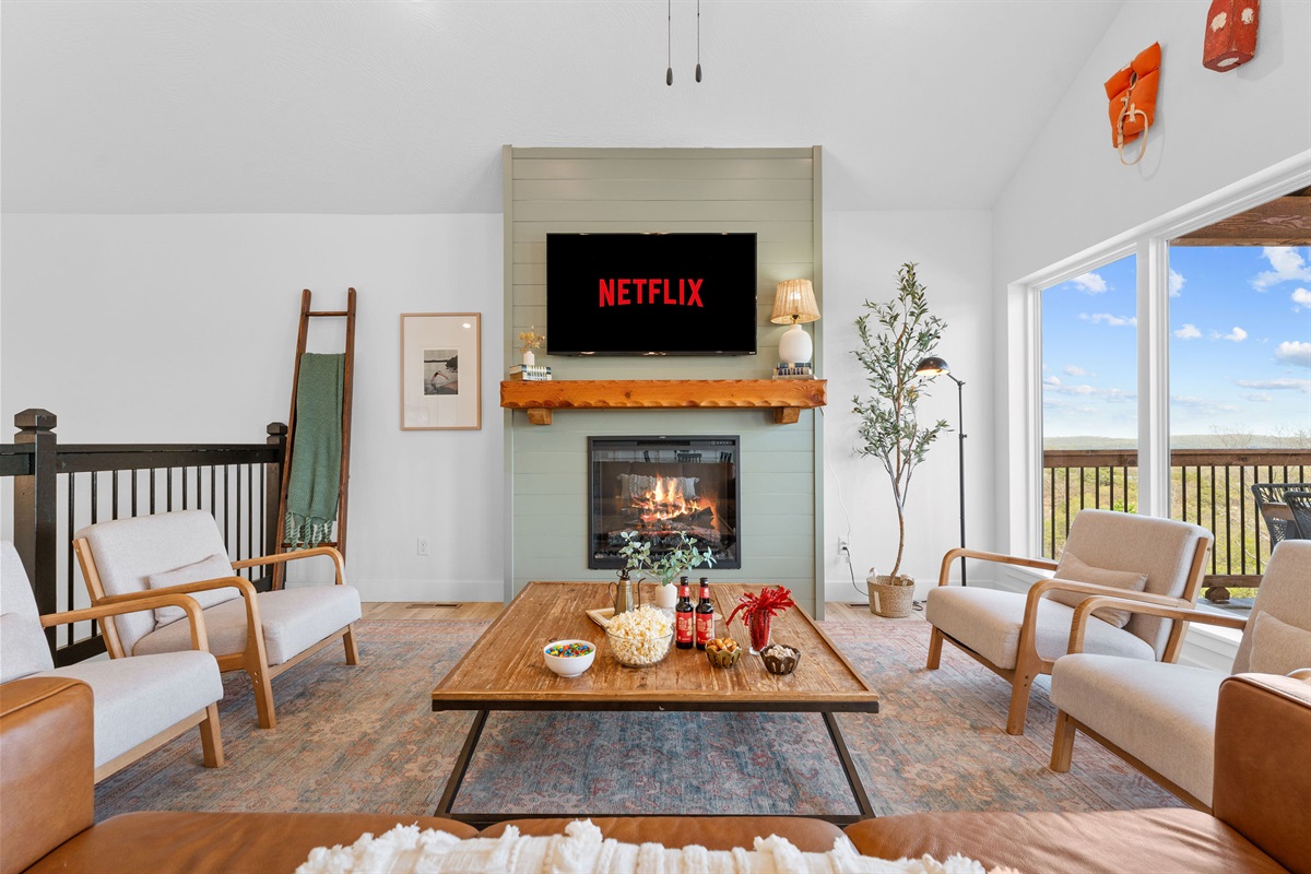 Cozy up by the fireplace and enjoy movie night on the big screen.