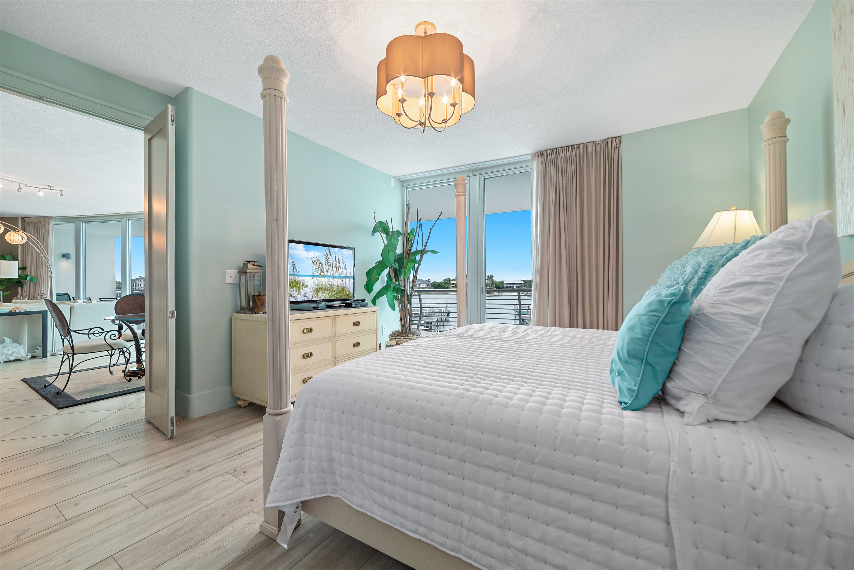 Experience the ultimate in comfort and style in this elegant primary bedroom. Featuring a cozy king-size bed, tranquil color palette, plush furnishings, and breathtaking views, this space offers a peaceful sanctuary for relaxation.