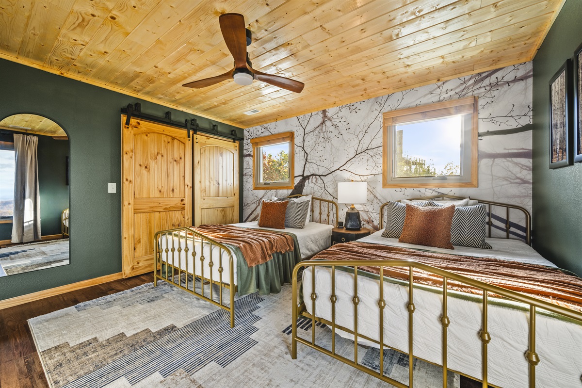 2nd floor: Unwind in the bedroom at Signature Stay, with two full beds and a TV for a cozy, relaxing stay