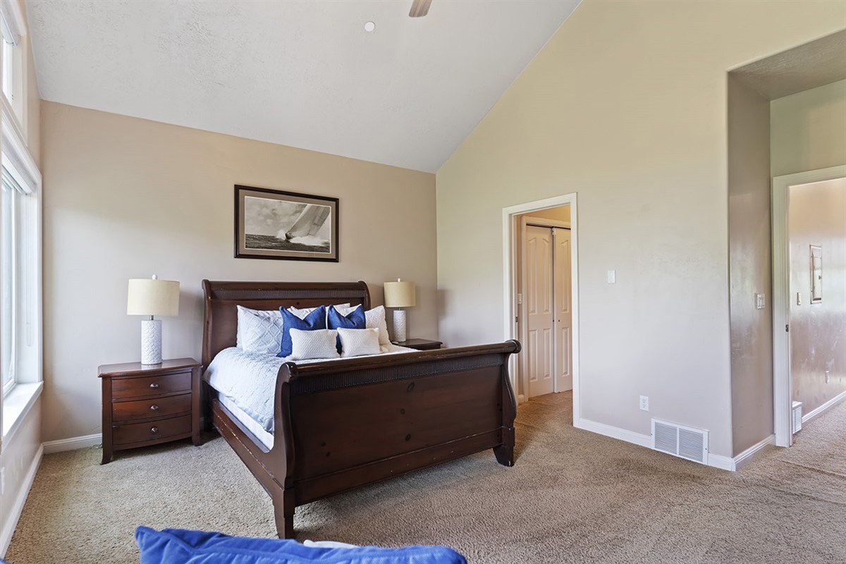 An inviting and spacious bedroom featuring a plush queen bed and the perfect setting to relax and unwind.