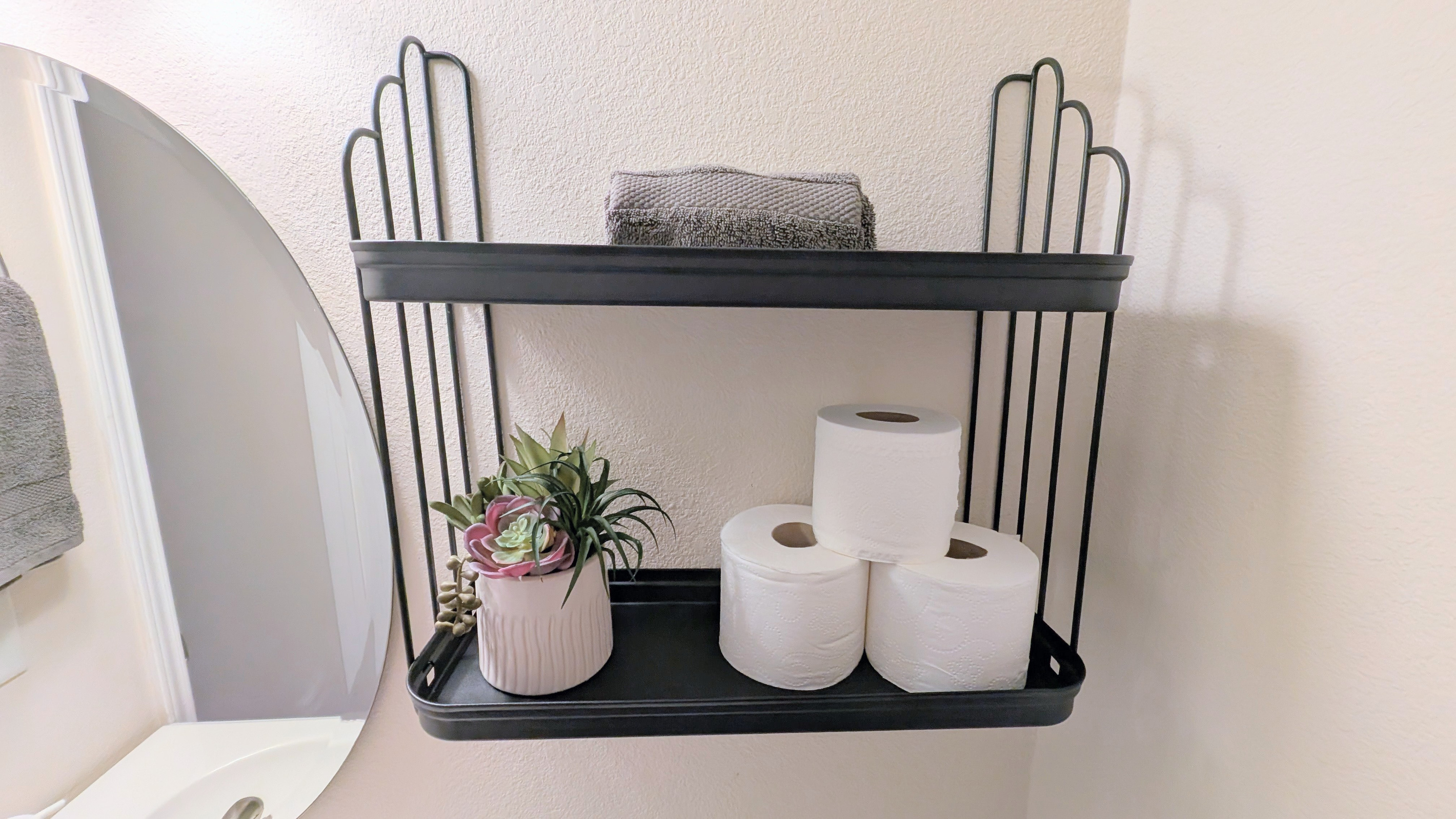 Half bath has plenty of toilet paper, hand soap, fresh towels, and a step stool for children.