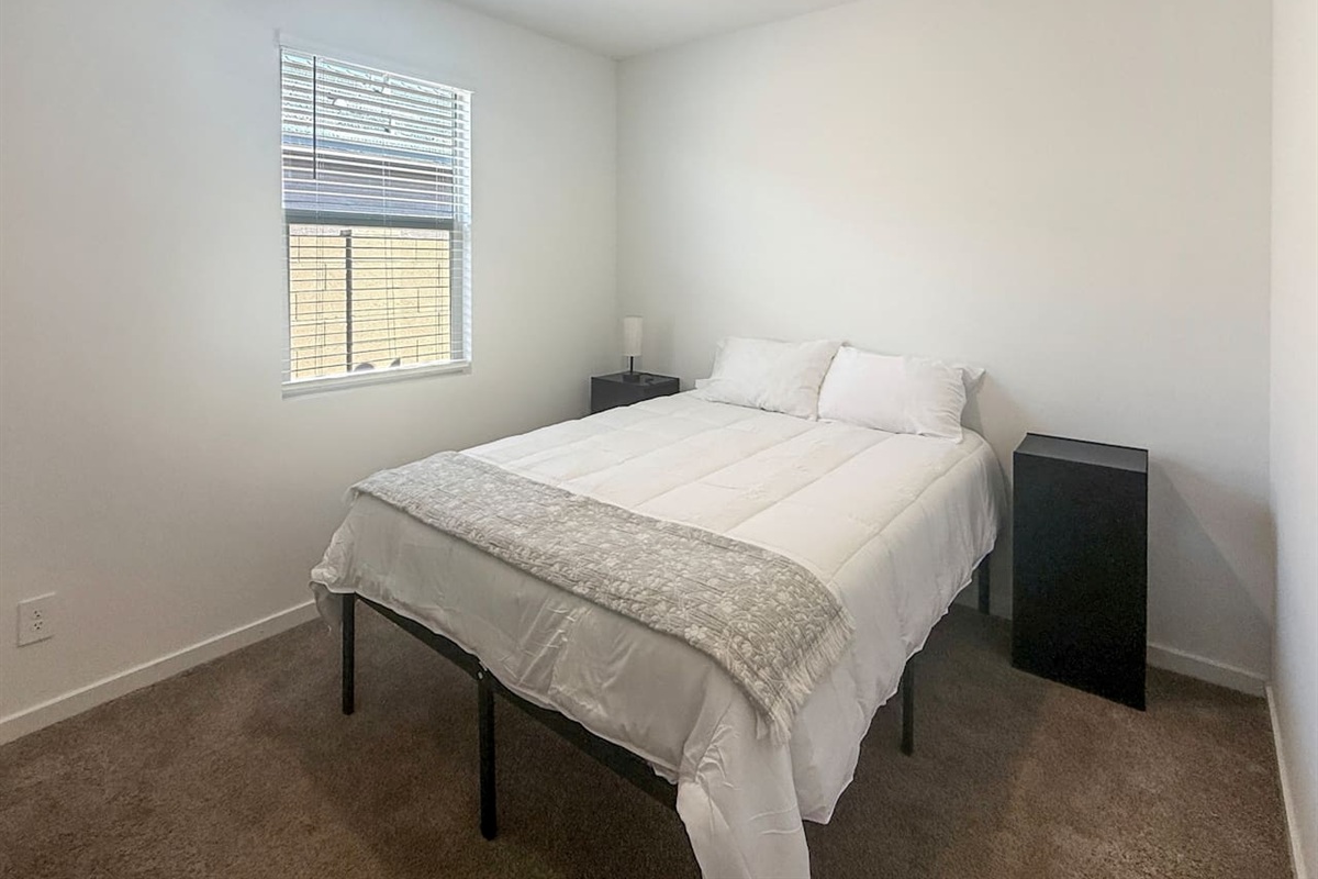 Bedroom with bed, nightstand, and window