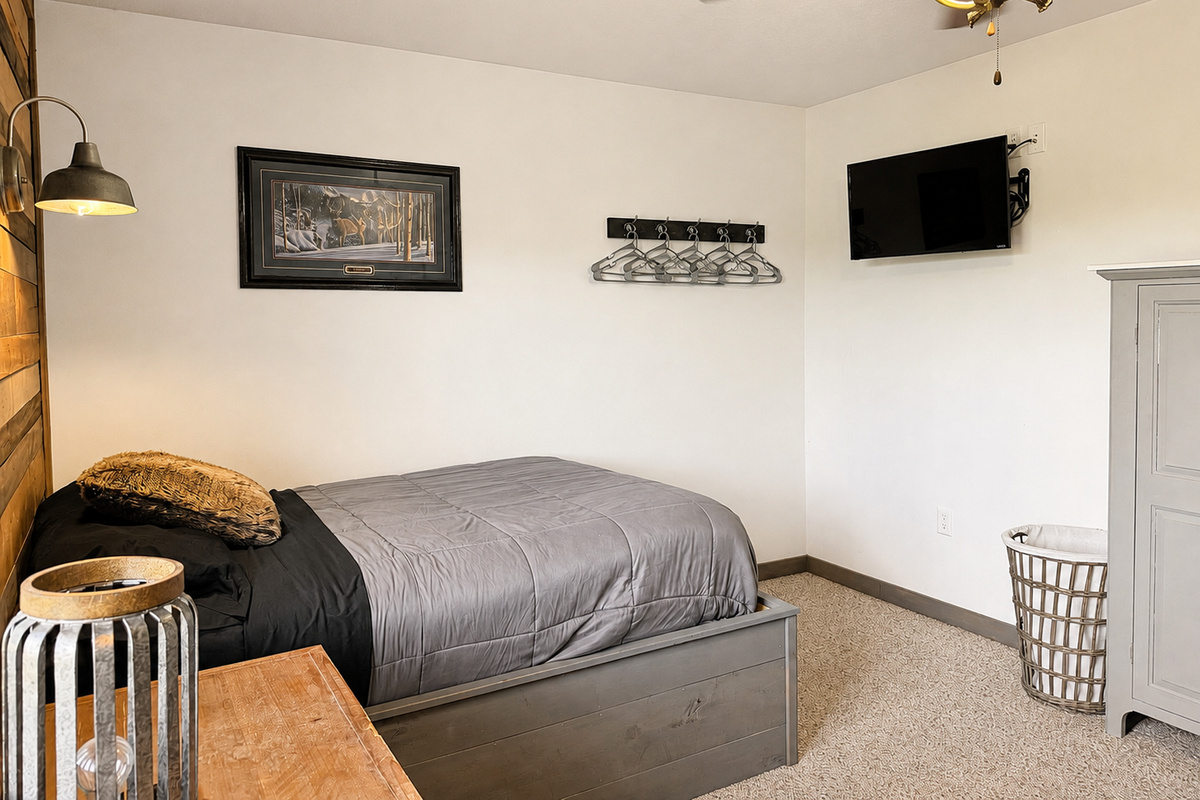 This bedroom comes with its own wall-mounted TV as well, giving guests a private place to kick back, relax, and enjoy a little downtime at the end of the day.
