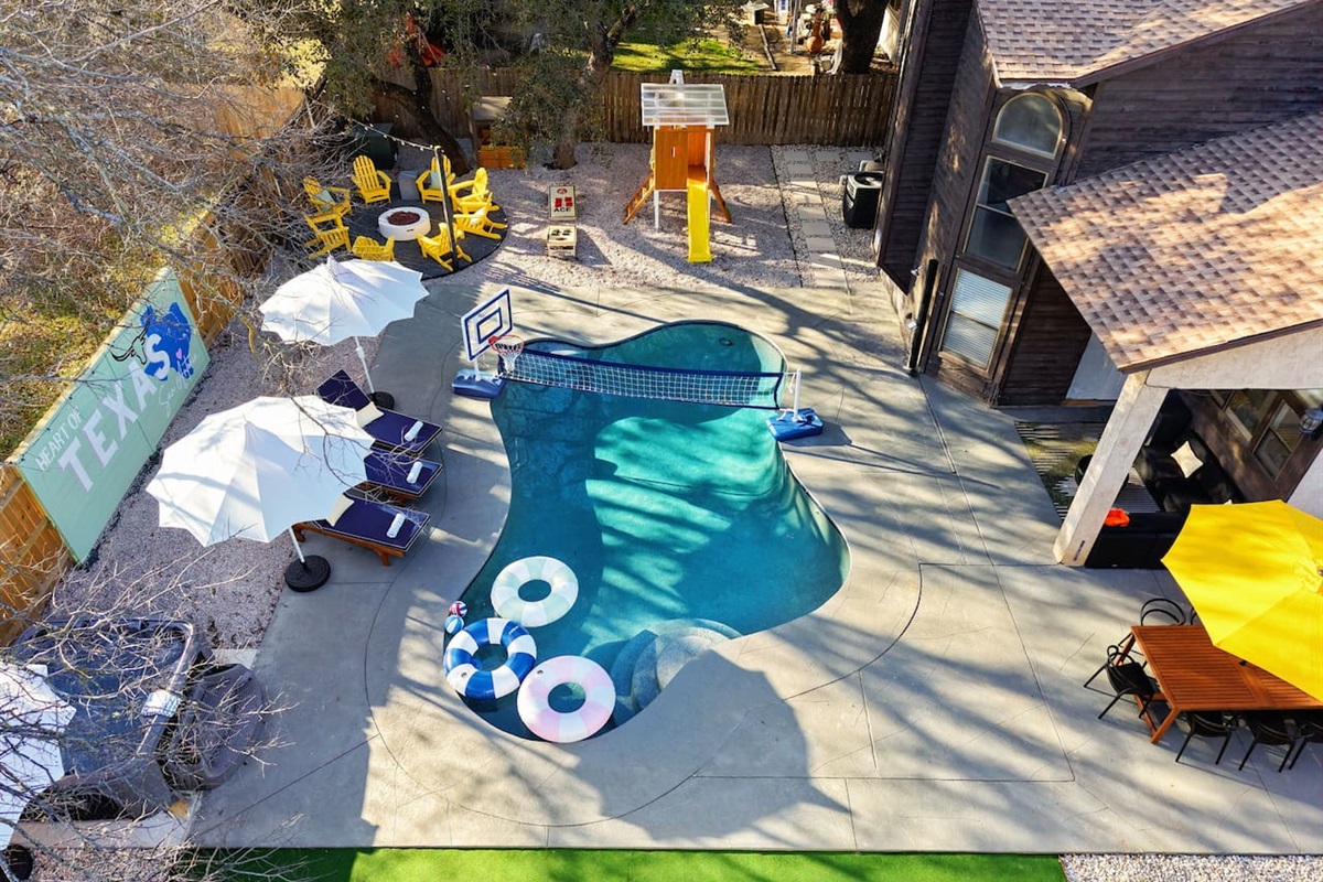 A backyard built for memories—private pool, volleyball, fire pit, hot tub, outdoor dining, and a kids’ play area, all wrapped in fun & Texas flair. Perfect for your group’s getaway
