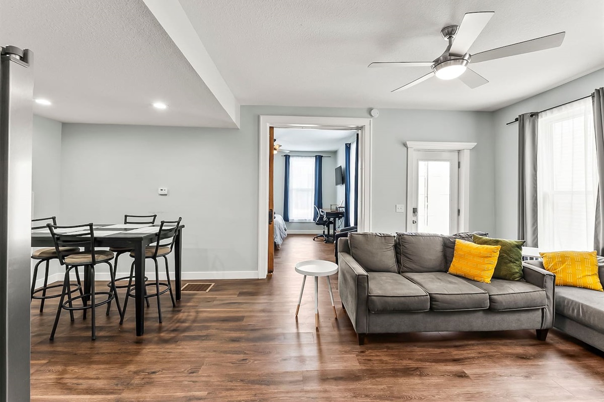 Open-concept living room flows seamlessly into the dining area, creating a bright and comfortable space for relaxing or entertaining in downtown Fort Wayne.