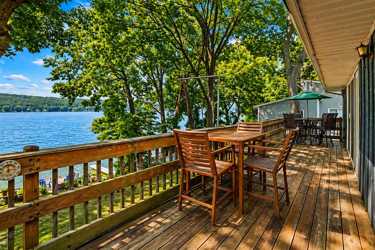 Relax on the spacious deck with stunning views of Honeoye Lake, surrounded by nature. Perfect for dining al fresco or simply soaking in the tranquility. 