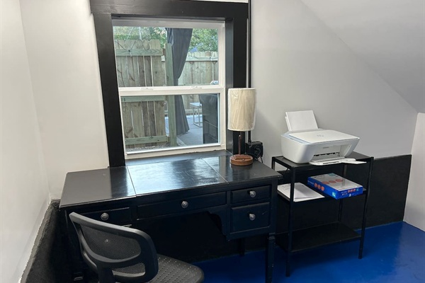 Desk, printer, lamp w built in charging ports. Sunny, bright room to lighten your work.
