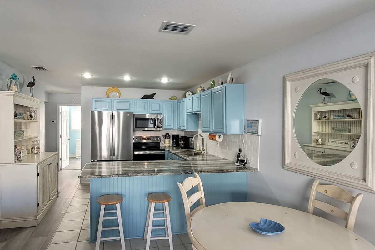 Cook the real vacation meal here &mdash; stainless steel appliances, updated surfaces, and a hutch stocked for storing your groceries.
