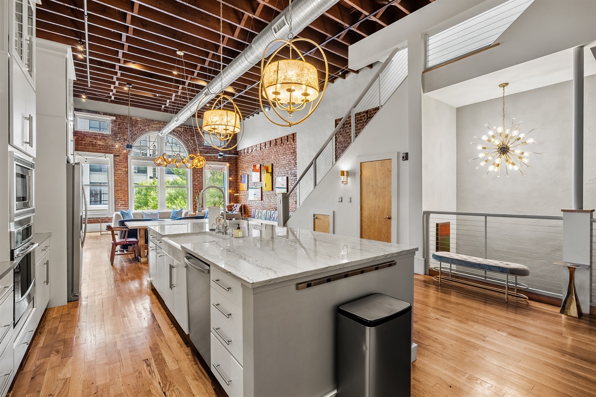 Fully equipped chef’s kitchen with granite countertops and bar seating.