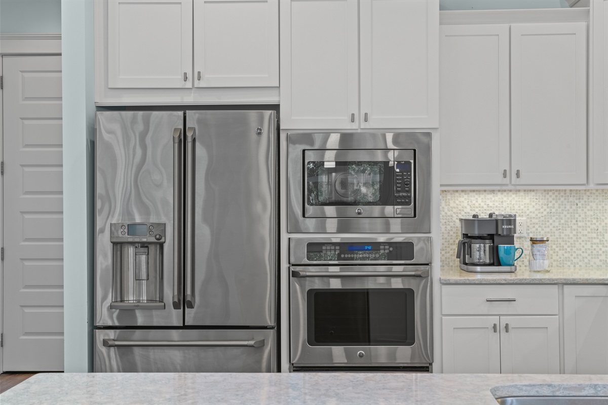 The kitchen boasts stainless steel appliances and granite countertops.