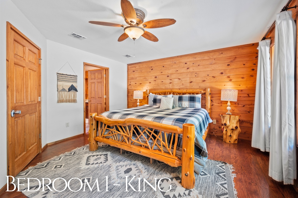 Rustic wood frame king bed with ensuite access and natural light.