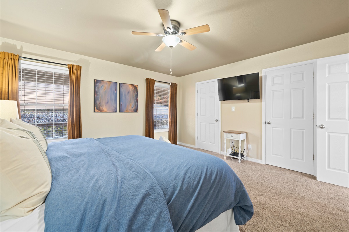 Cozy bedding and gentle lighting make this comfortable king room a lovely place to enjoy quiet mornings or restful nights.