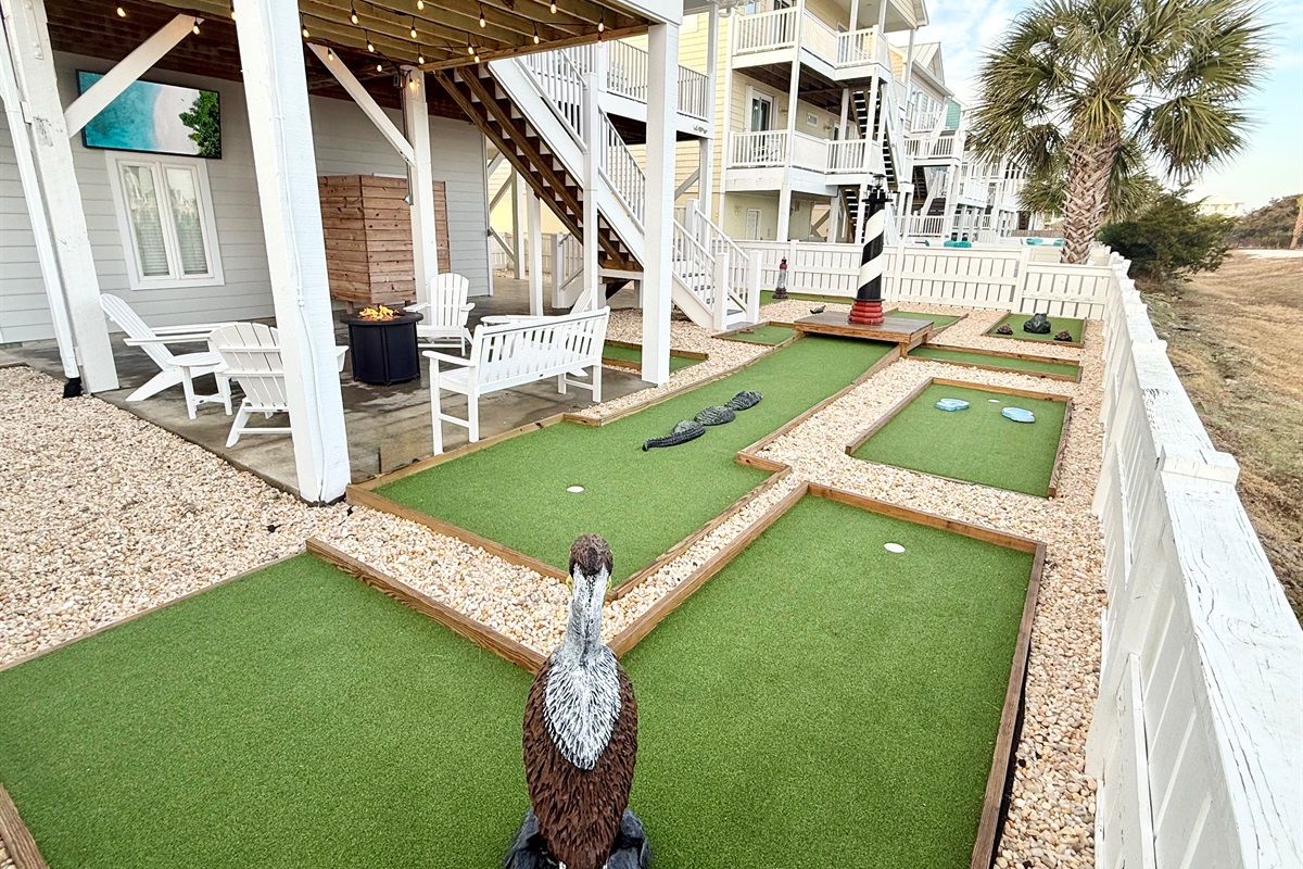 Backyard putt putt with fire pit and TV