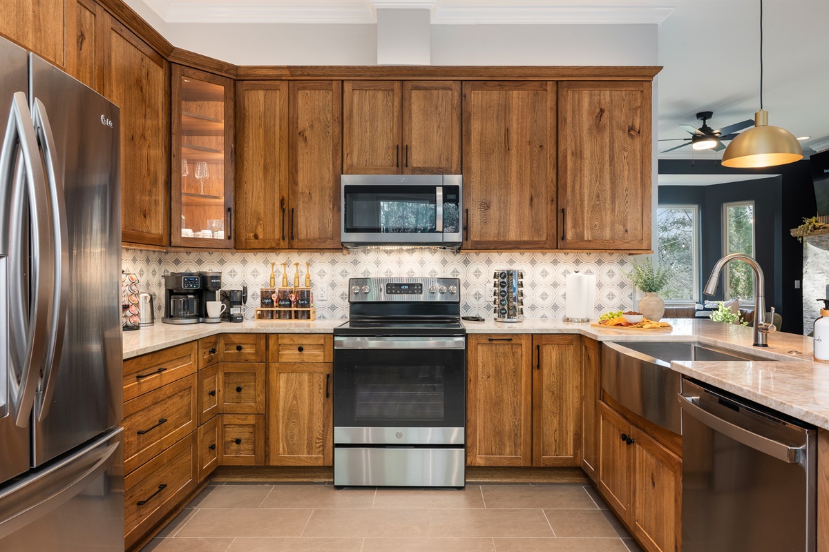 Full kitchen with ample counter space and storage - makes cooking and hosting simple during your stay
