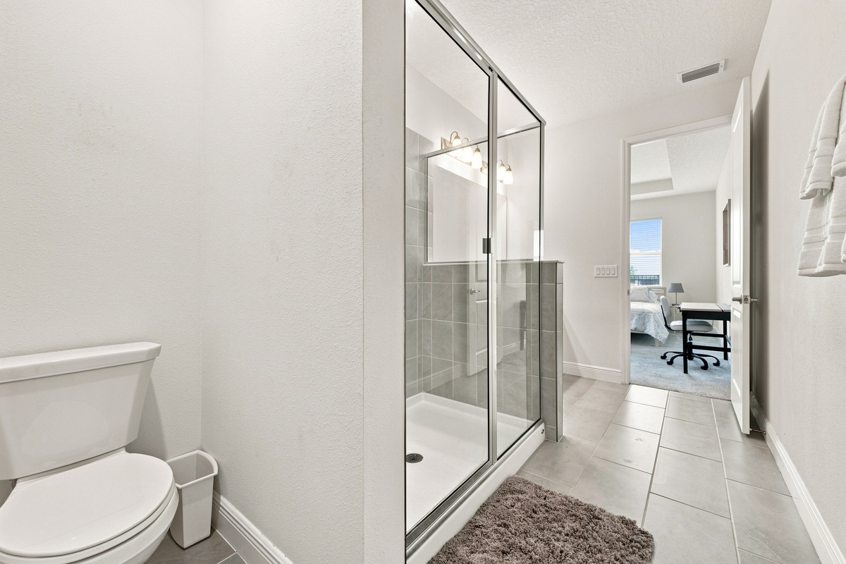 Private toilet nook at far end of bathroom. 