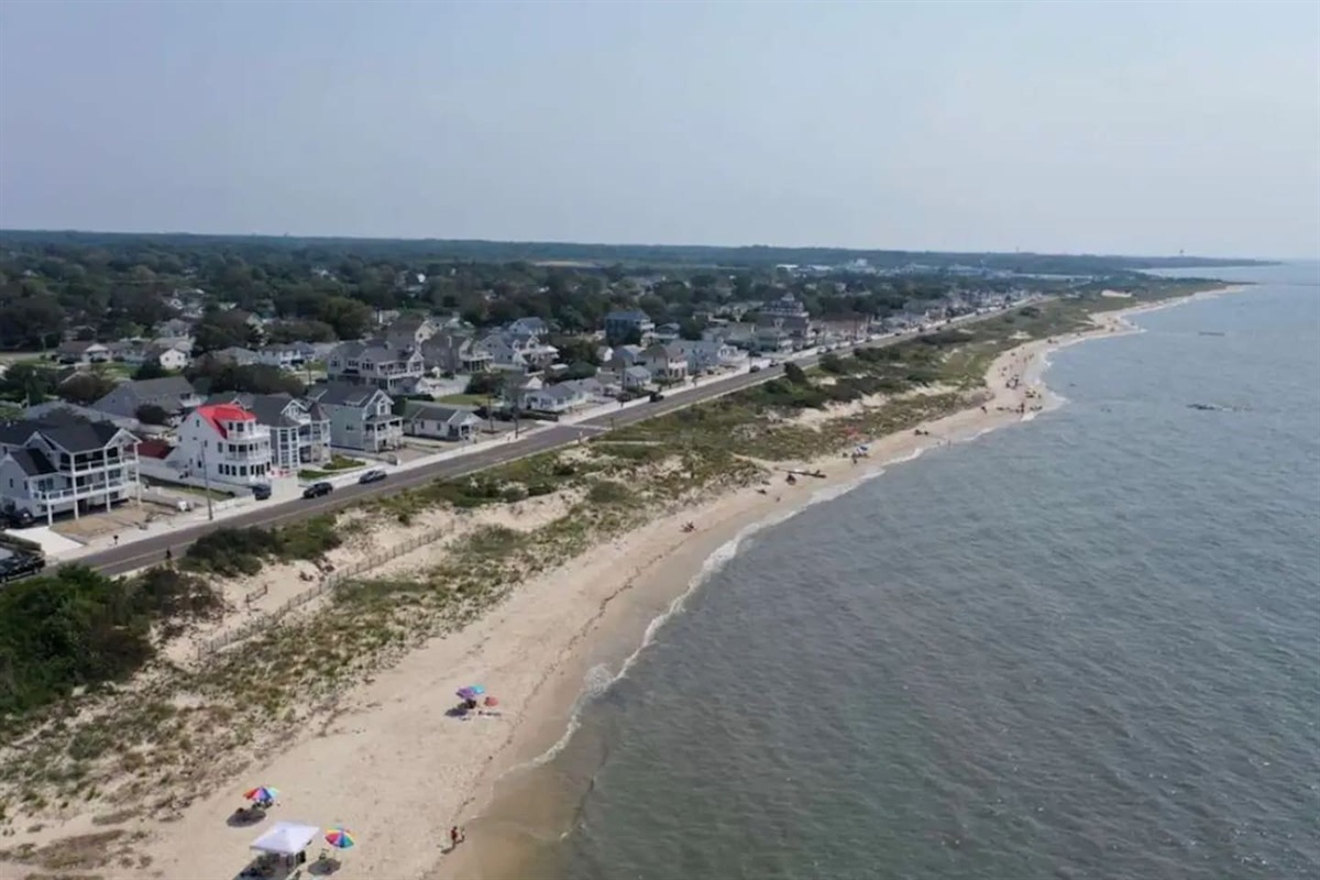 This aerial view highlights the property's incredible proximity to the coast. You are just a short, easy walk away from the sandy shoreline and the calming waves of the ocean.