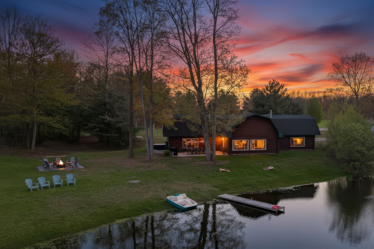 View of dock, outdoor seating, fire pit and our home from the pond.