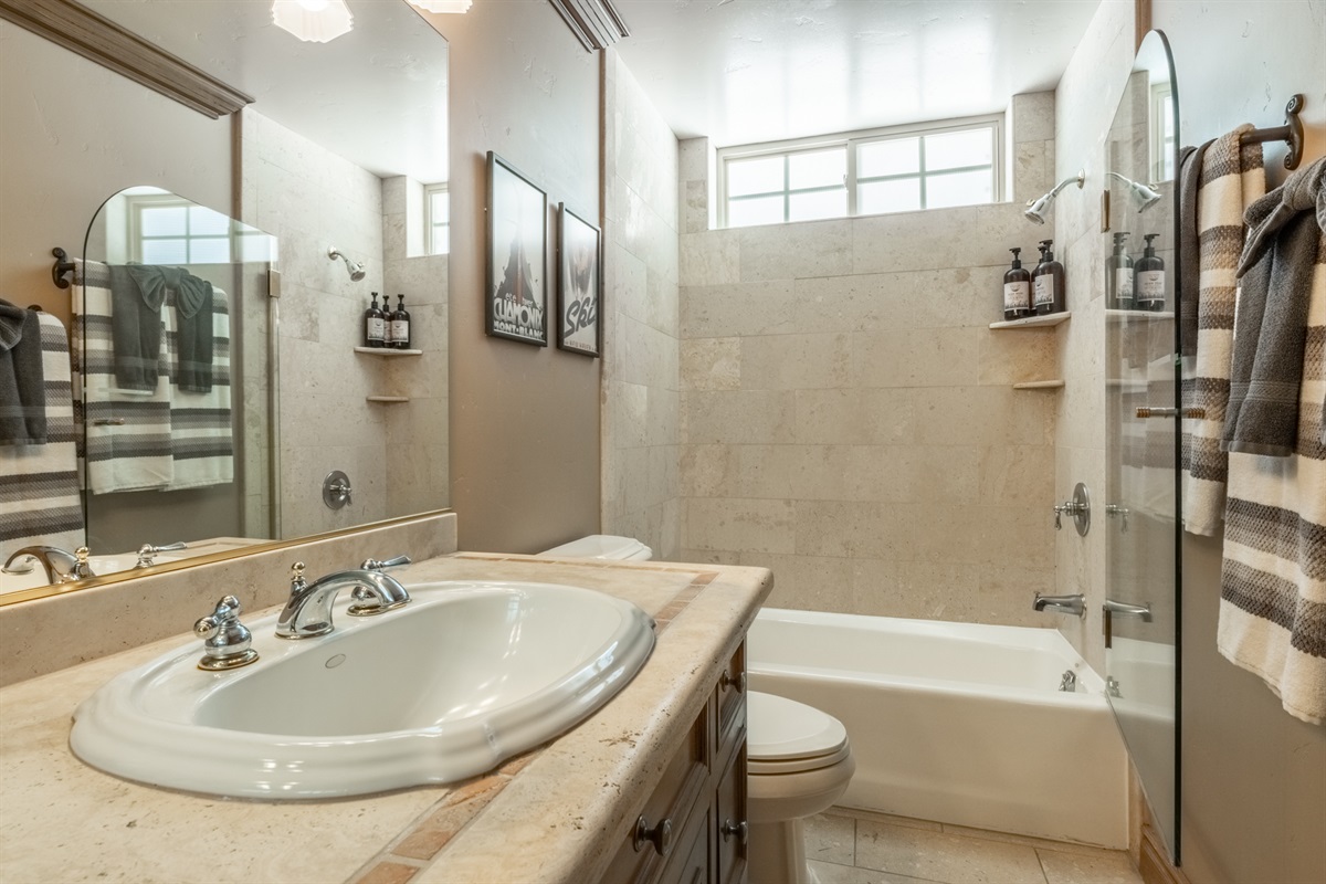 Hall bathroom with a single vanity and tub/shower combo—clean, functional, and conveniently located to the guest bedrooms.
