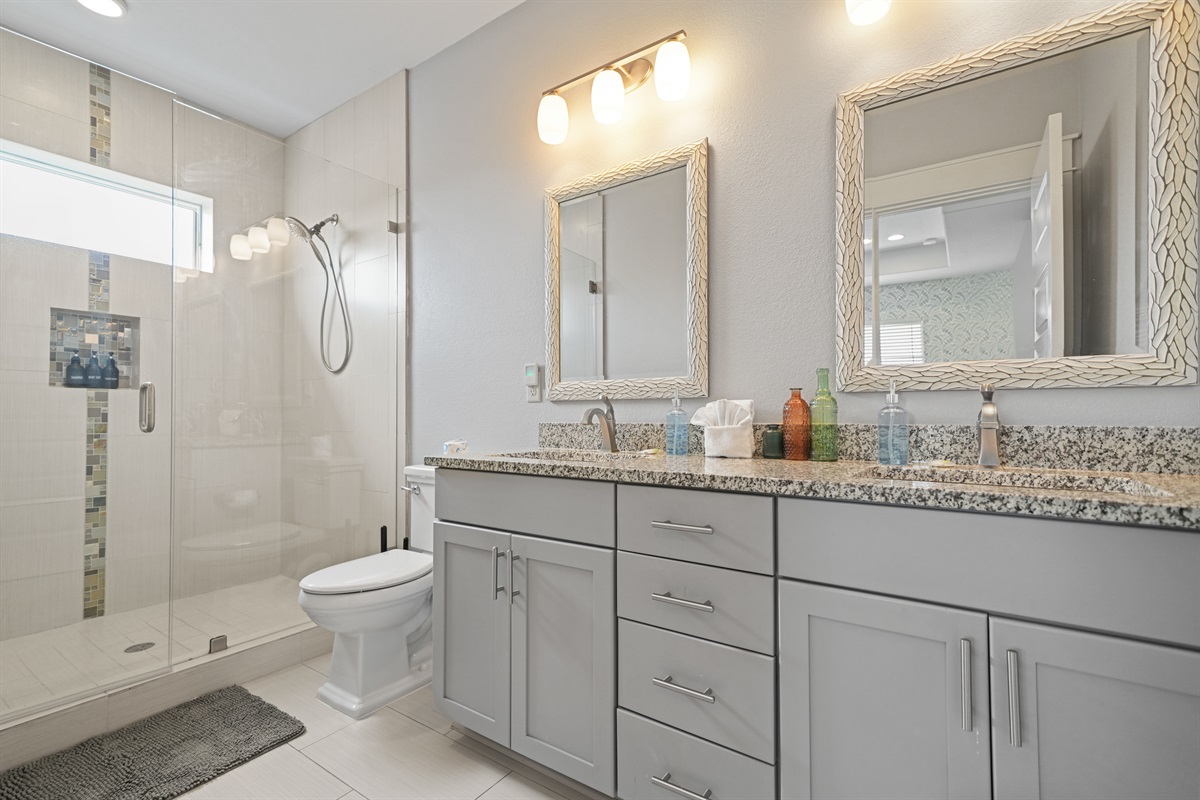 Spacious Grand Master ensuite bath with double vanity, granite countertops, and walk-in shower.