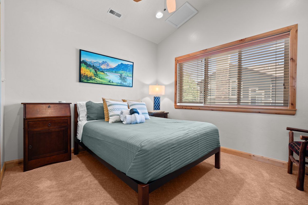 Main floor bedroom with comfortable queen bed and peaceful mountain ambiance.