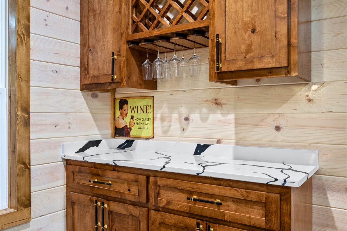 A charming built-in bar area keeps wine glasses and your favorite drinks close at hand for relaxed evenings at the cabin.