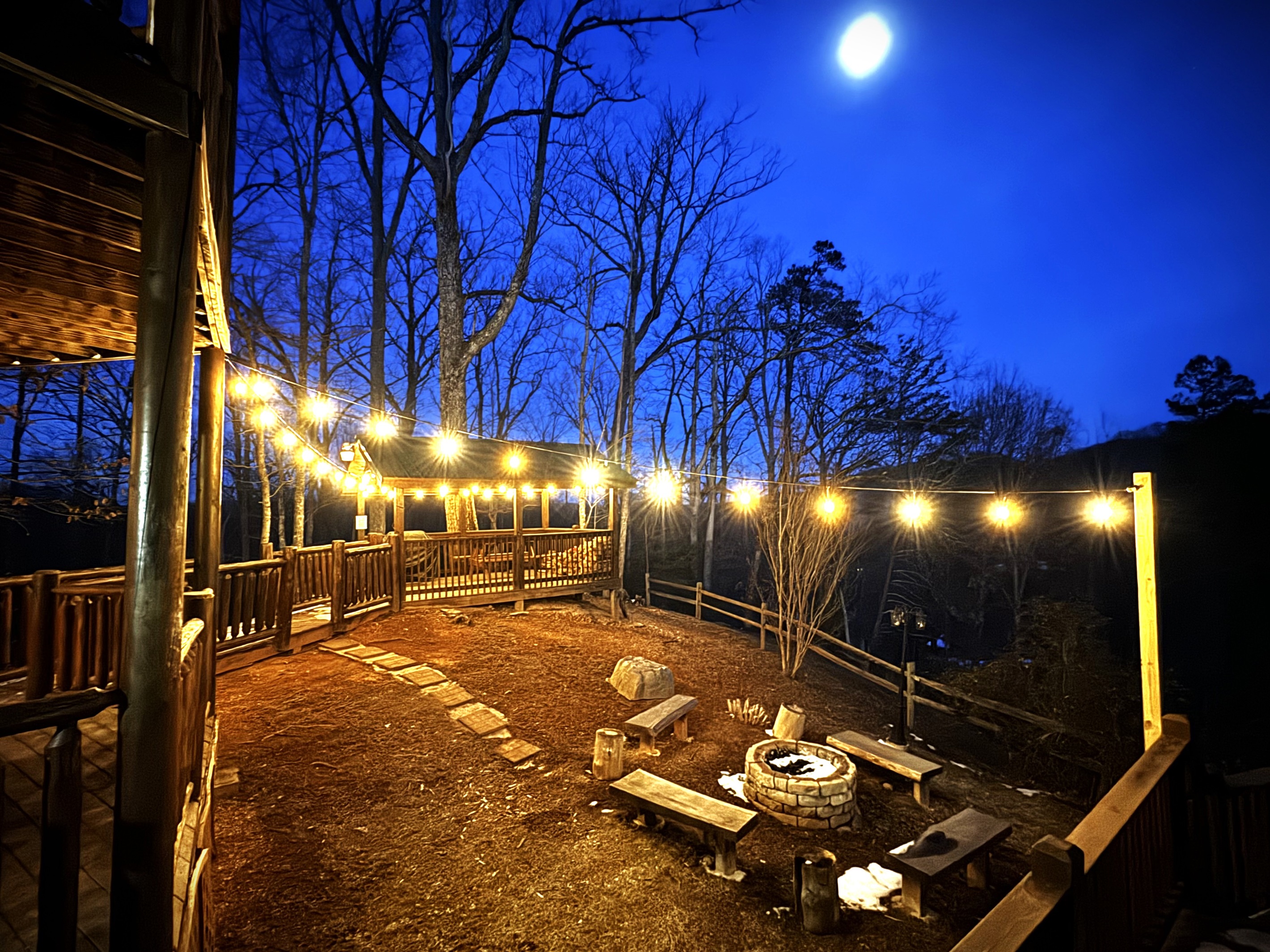 Firepit area at night with lights