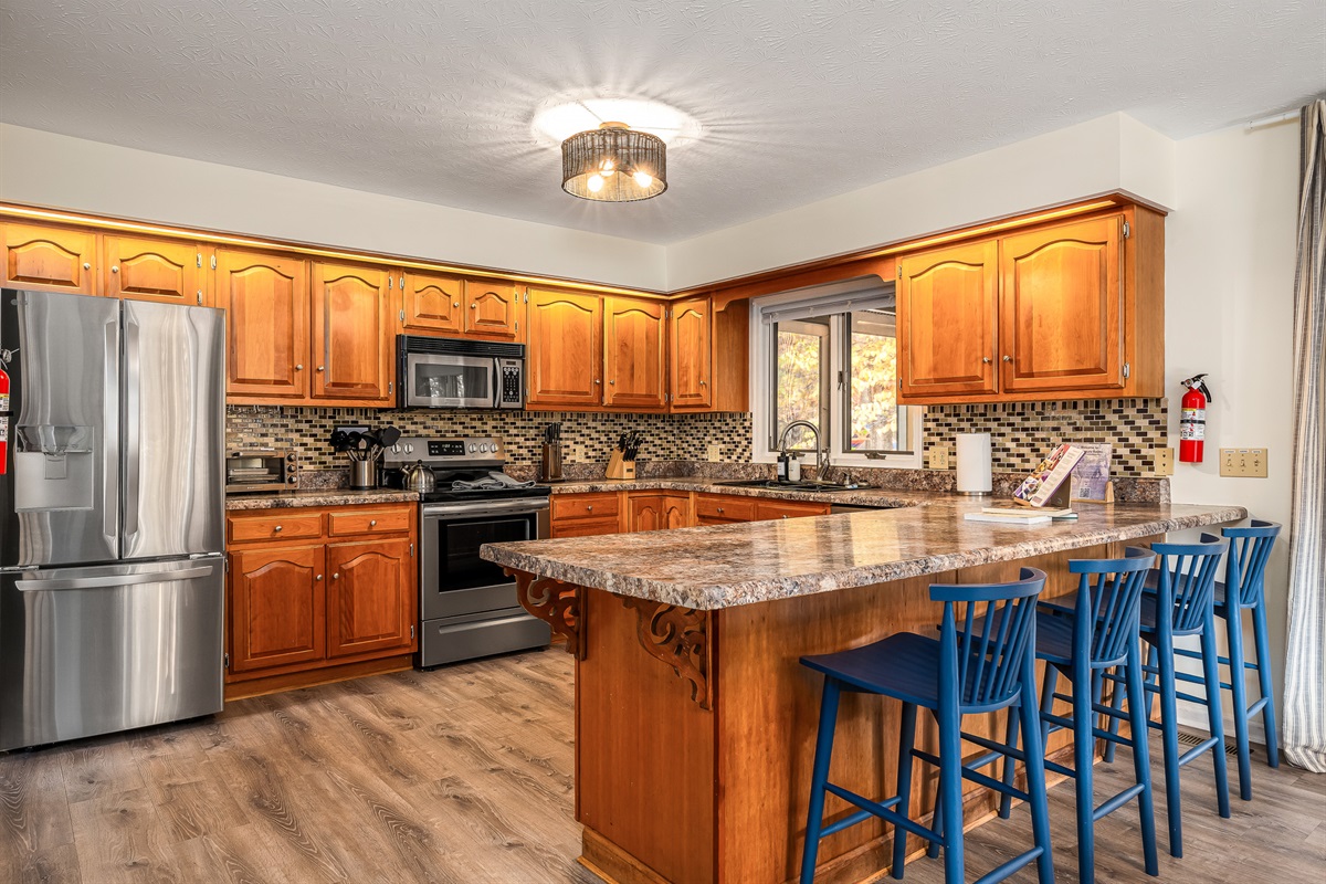 Plenty of room for the whole crew — kids at the counter, cooks in the kitchen, and everyone still together.