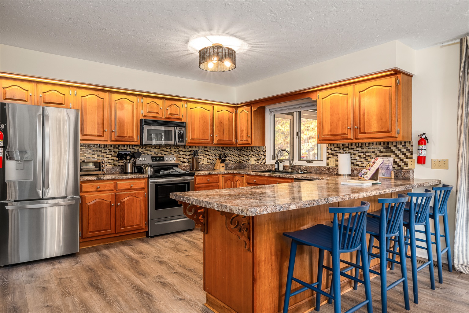 Plenty of room for the whole crew — kids at the counter, cooks in the kitchen, and everyone still together.