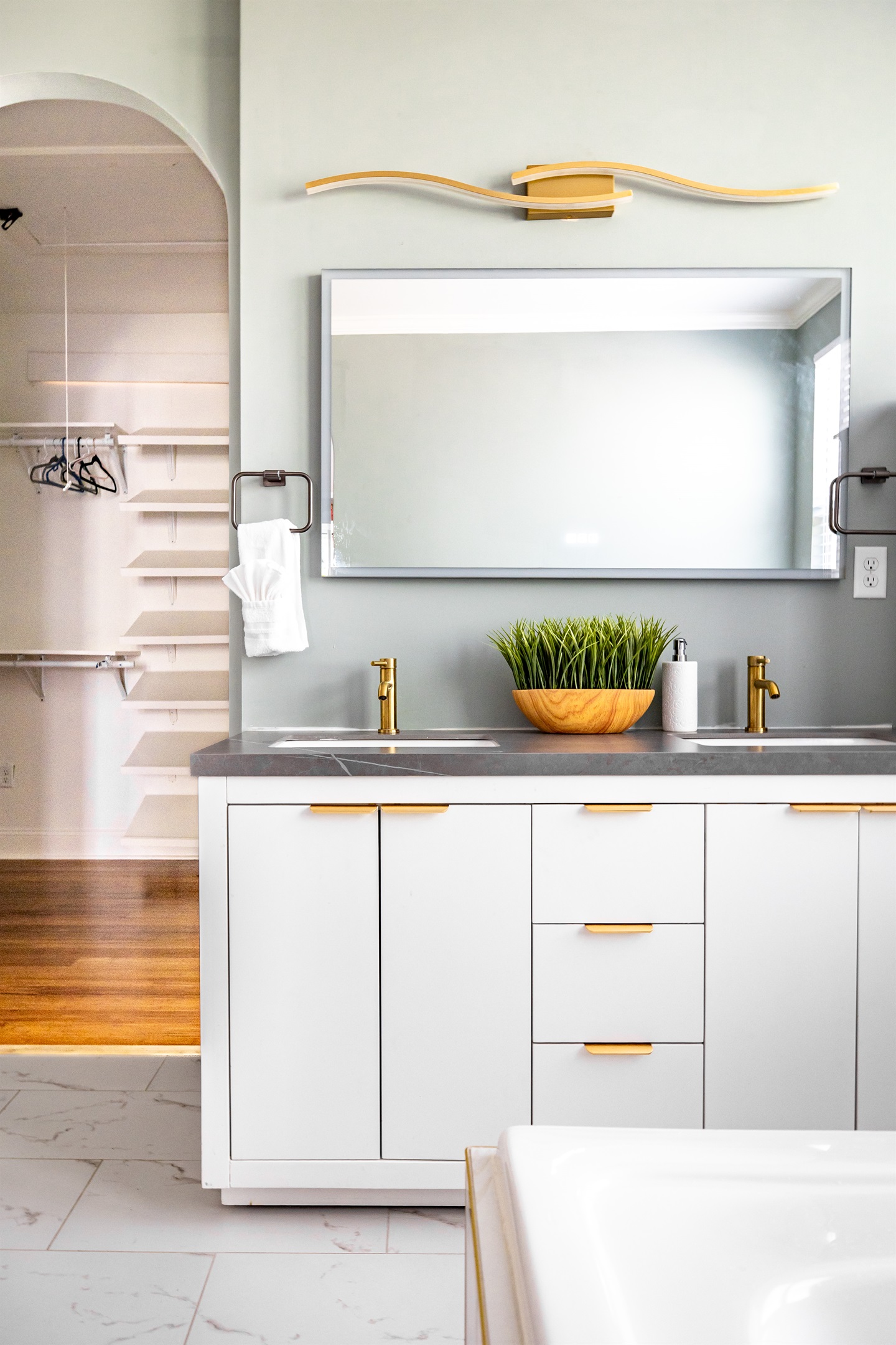 Luxury en-suite bathroom with 2-person air massaging bath, tiled rain shower, double vanity, walk-in closet