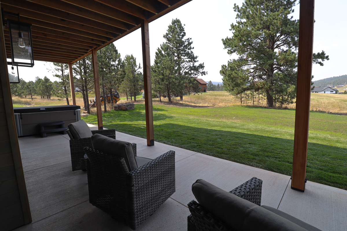 Back patio with seating and private hot tub