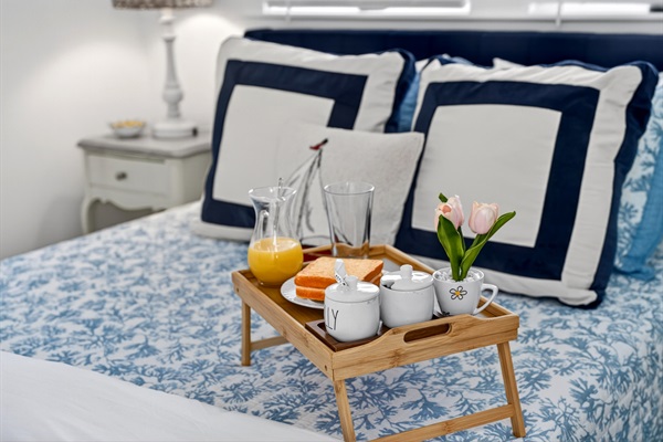 Bright queen bedroom with easy bathroom access and direct entry to the second-floor deck.