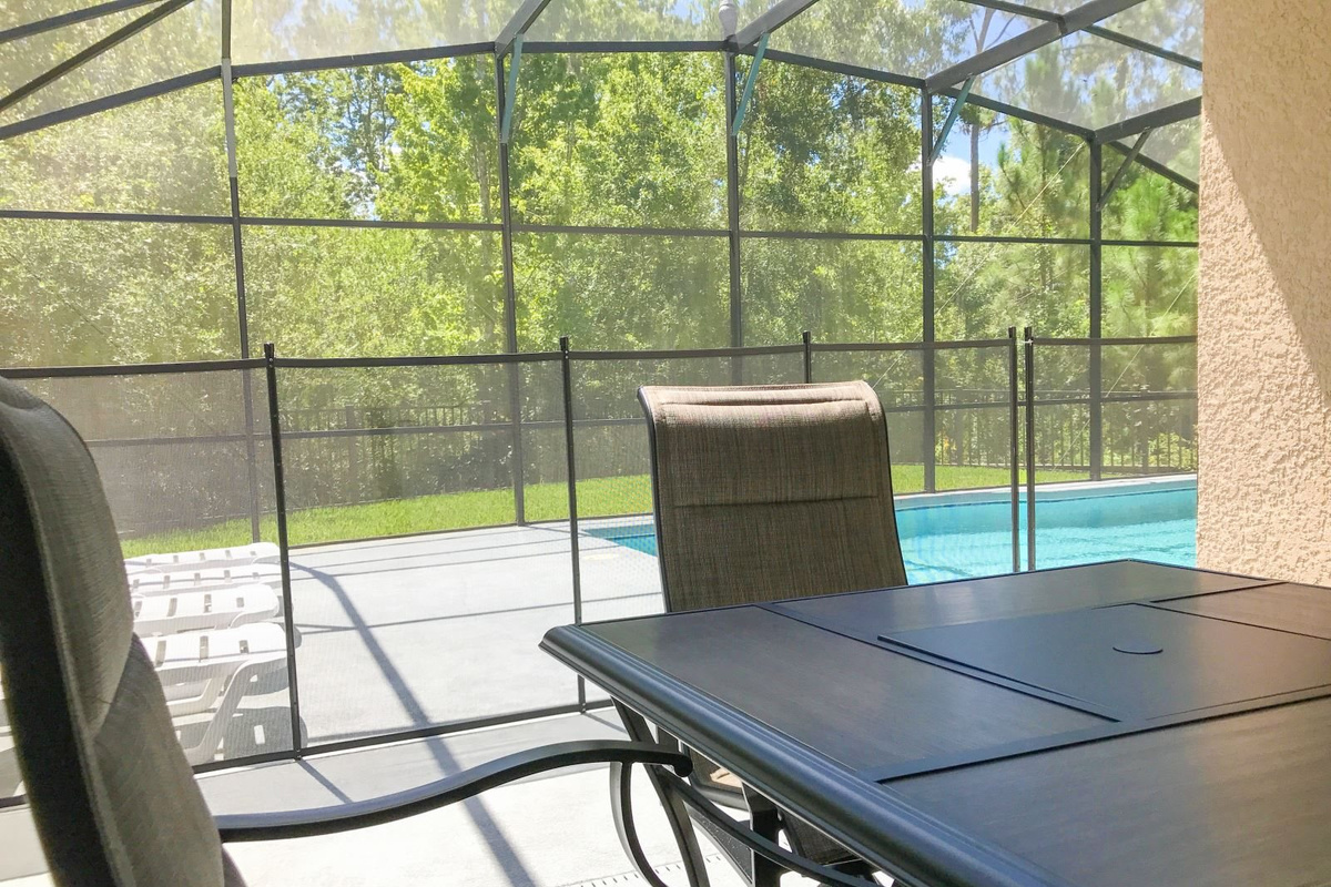 Outdoor dining area under covered lanai