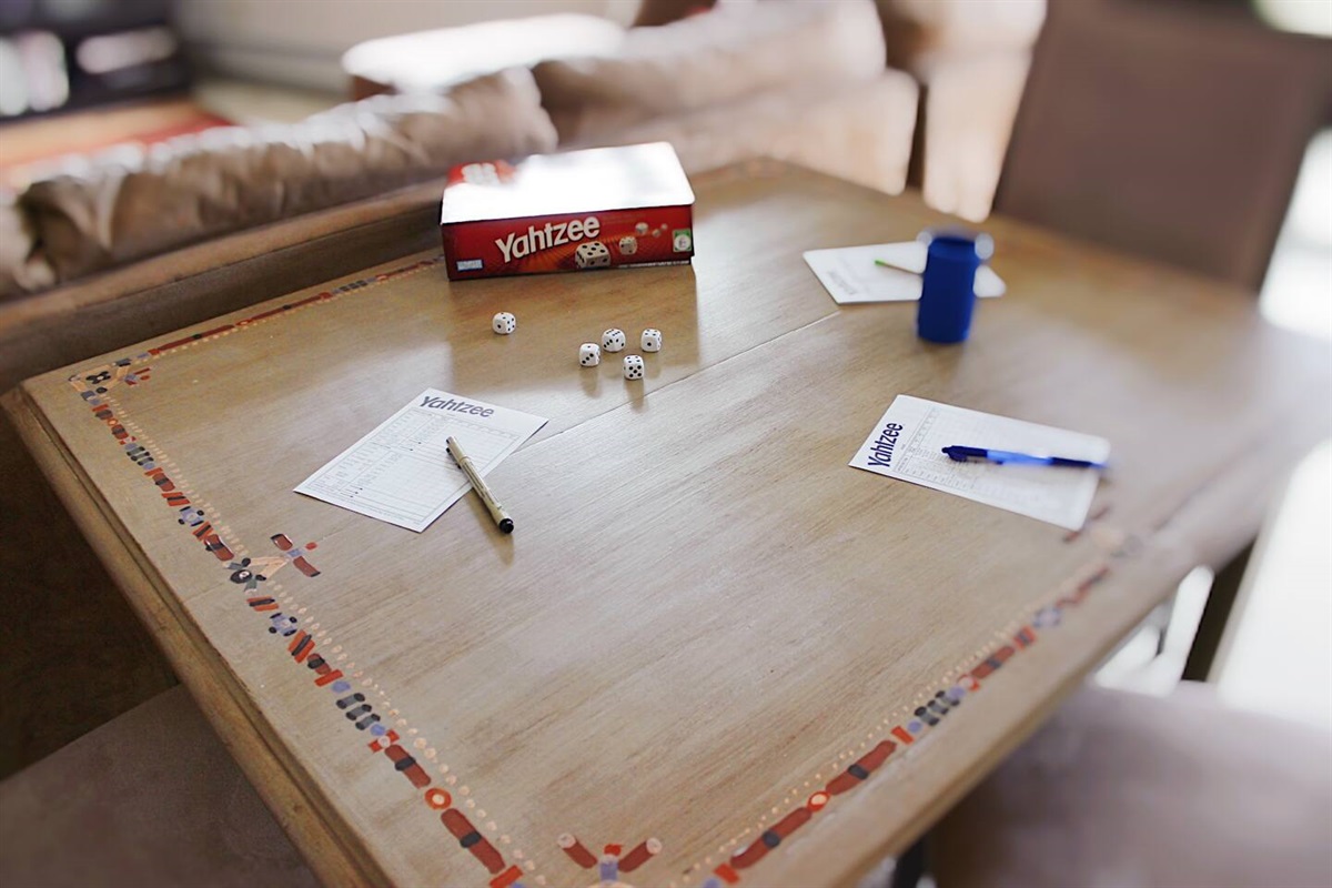 Unleash your competitive spirit and gather around the Yahtzee table in our inviting living room. Engage in thrilling games of strategy and luck with family and friends.