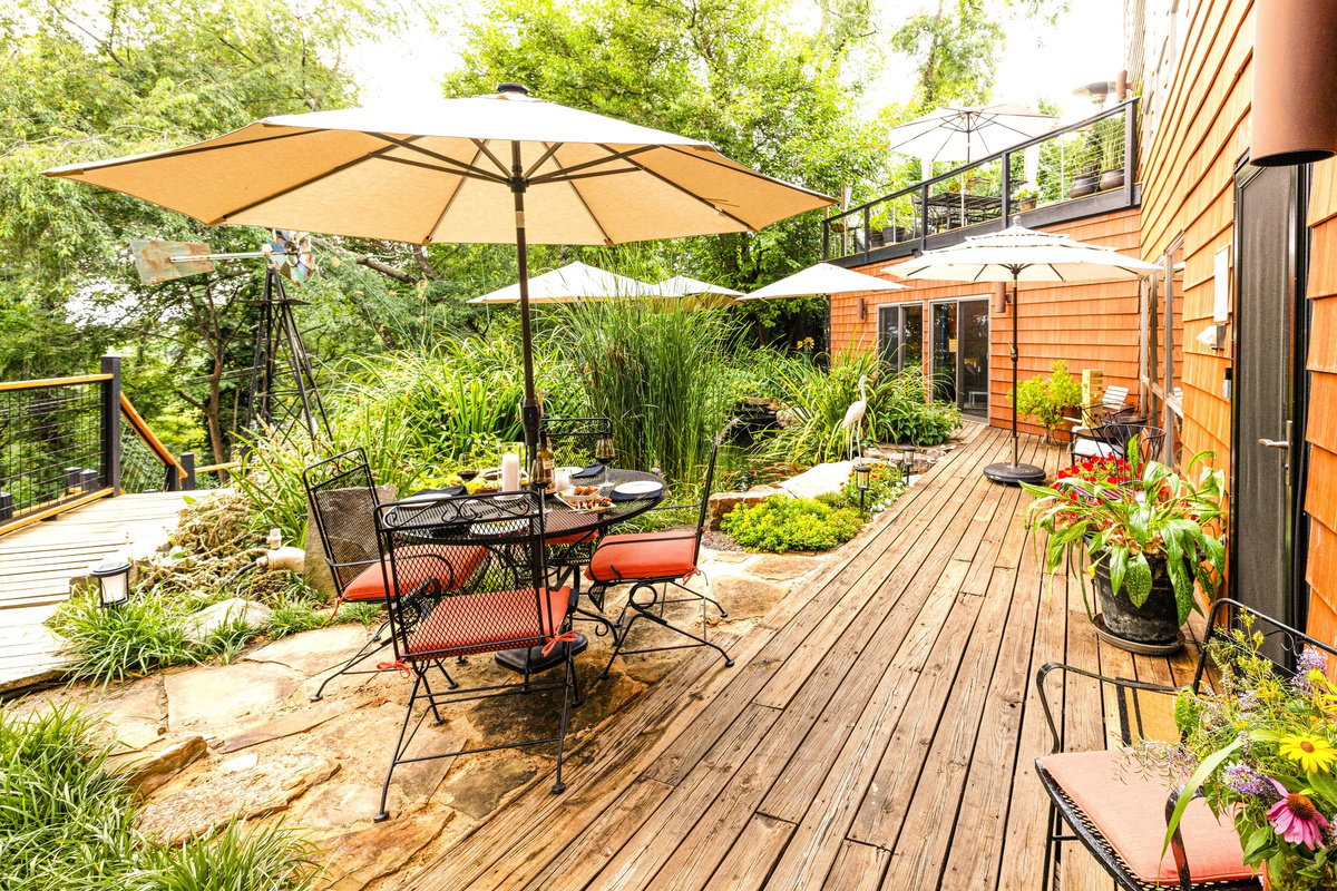 Outdoor deck and al fresco dining area at Hilltop Oasis Abingdon vacation rental in Abingdon, Virginia. Dine outside surrounded by gardens, the koi pond and Henrietta Heron guarding the fish. Have fun watching and feeding the Koi - they love watching you.