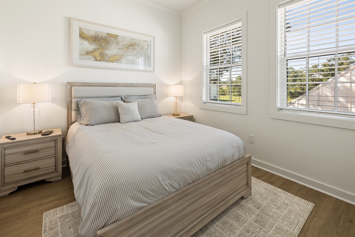 Second bedroom featuring a queen bed and relaxing beach-inspired décor.