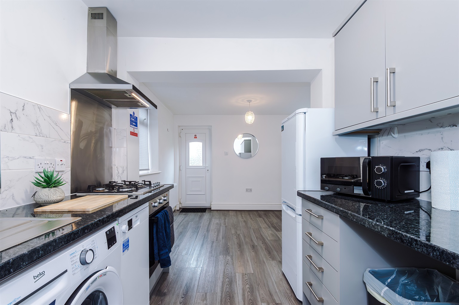 The modern, clean kitchen benefits from utensils, crockery, microwave, oven, hob, fridge freezer, washer & dishwasher 