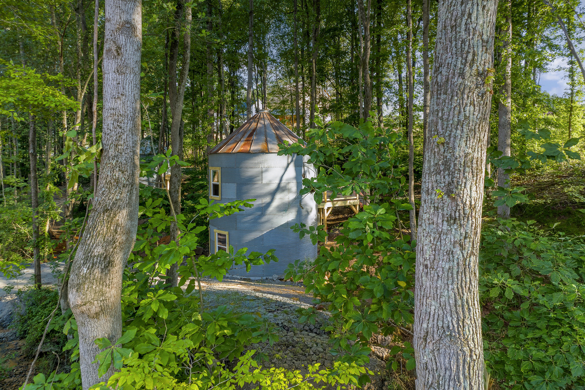 Unique Getaway: Experience this charming round retreat nestled among tall trees!