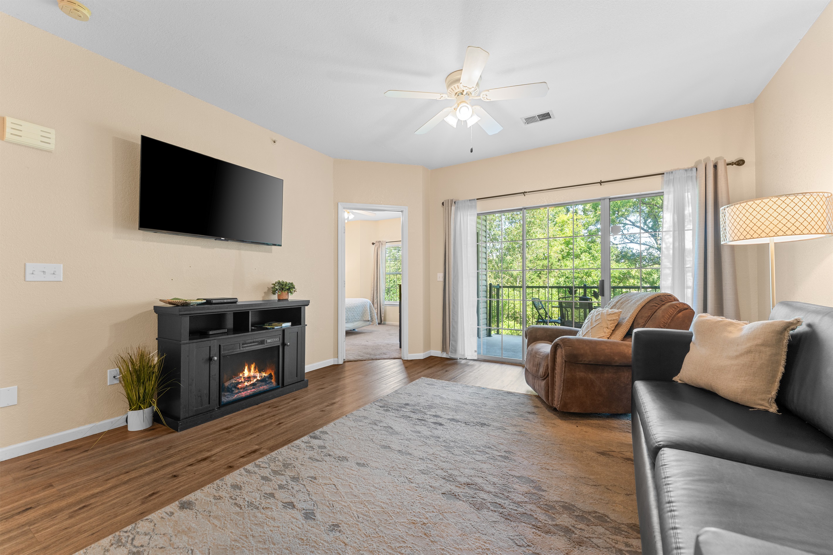 Settle into the condo’s main living space, with a fireplace, big TV, and easy access to the private golf-view deck.