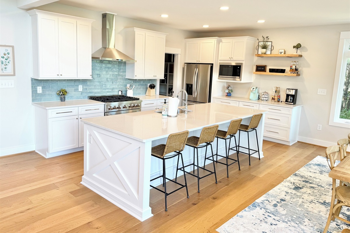 Gorgeous gourmet kitchen with 10 ft quartz island, Restoration Hardware dining table seating 12  and walk-in pantry stocked with all the basics.  Walk out to large screen porch with lake views!