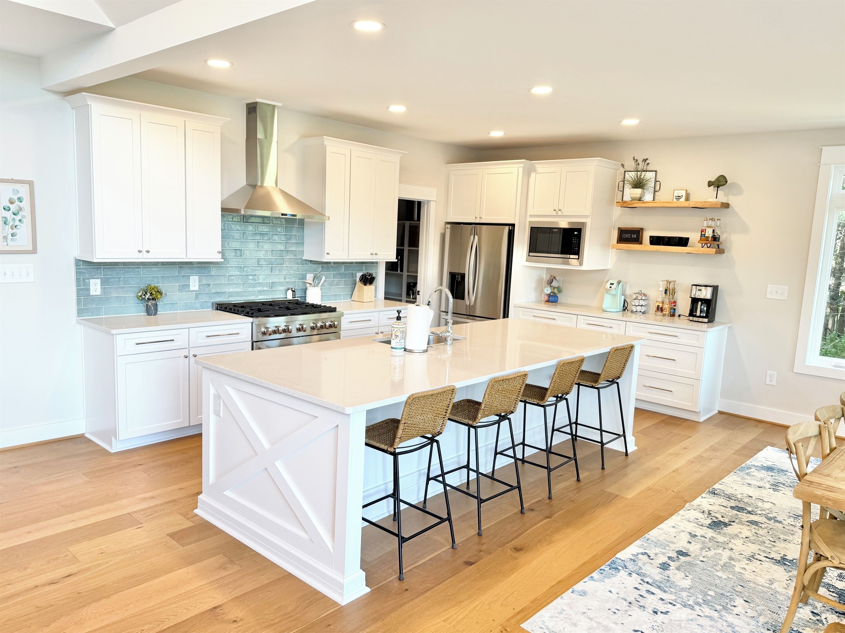 Gorgeous gourmet kitchen with 10 ft quartz island, Restoration Hardware dining table seating 12  and walk-in pantry stocked with all the basics.  Walk out to large screen porch with lake views!