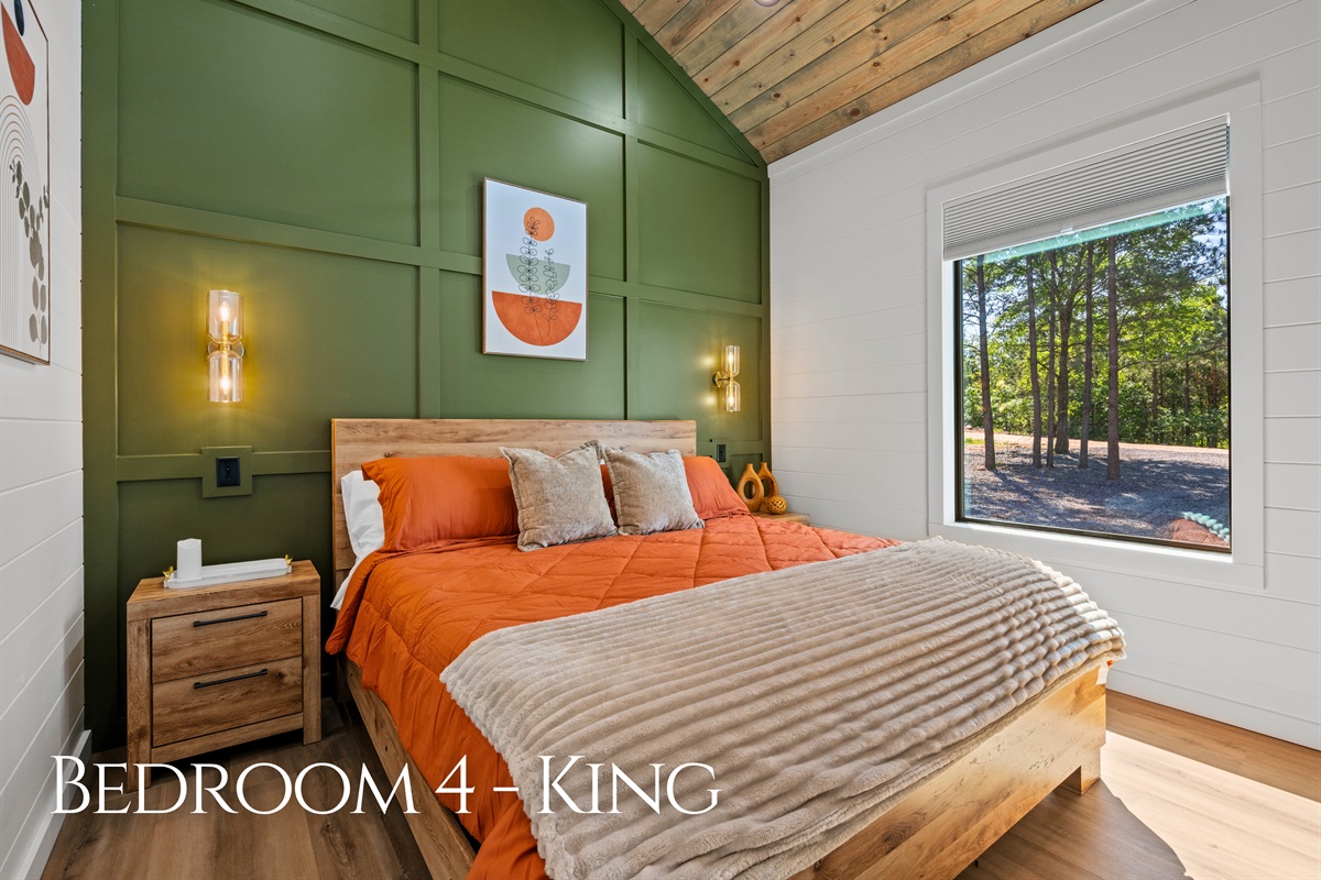 Earthy tones, colorful accents, and natural light give this king bedroom a fun and welcoming vibe while still maintaining a cozy cabin feel.